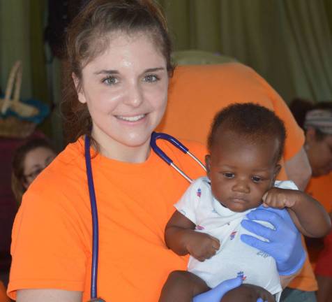 Nurse Katherine Juliano with a Haitian infant.