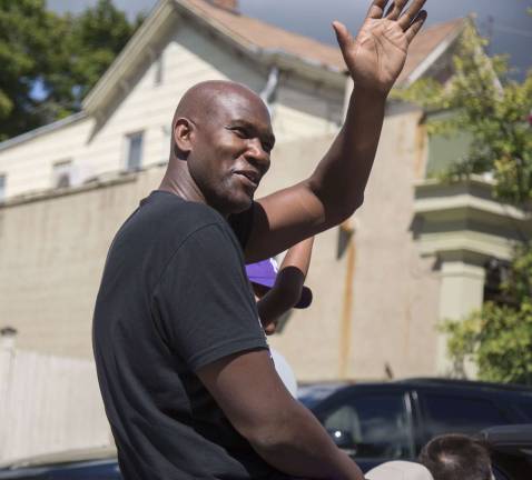 Crowds enjoy Homecoming Day Parade on Main Street Photo by Lisa Ramirez Dr. Larry Washington, the principal at Warwick Valley High School, waves to the crowd during Saturday's homecoming parade.