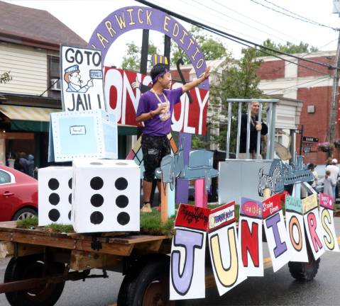 Crowds enjoy another Homecoming Day Parade on Main Street The junior “Monopoly” float.