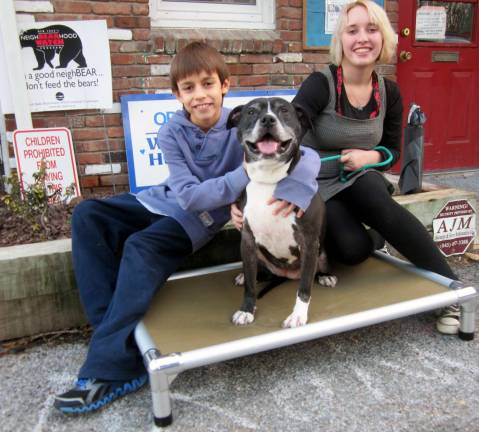 Christmas comes early for one old dog Shelter volunteers Ethan and Jane Tuomala pose with Tasha on her new all-aluminum Kuranda bed.
