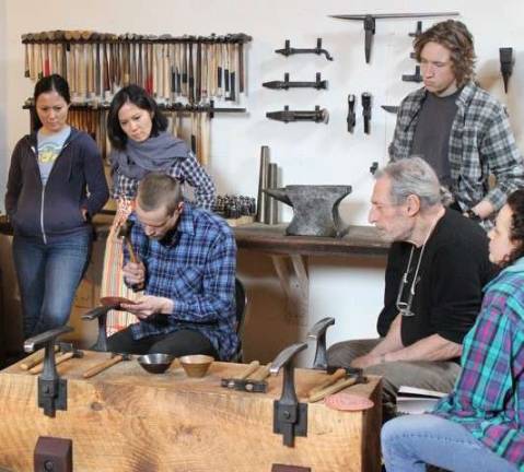 Center for Metal Arts Dan Neville (center left, seated) teaching a raising workshop in the metalsmithing studio.