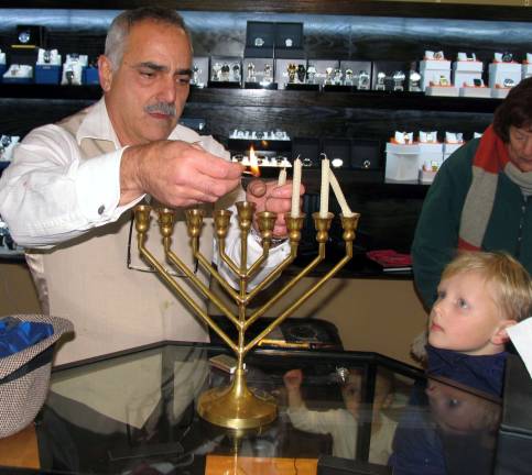 Warwick residents celebrate Hanukkah at 20th anniversary of Warwick Menorah lighting Moshe Schwartzberg repeated the ceremony, explaining the origin of the shamas, the ninth candle used to light the others, and lighting three other candles on a Menorah.