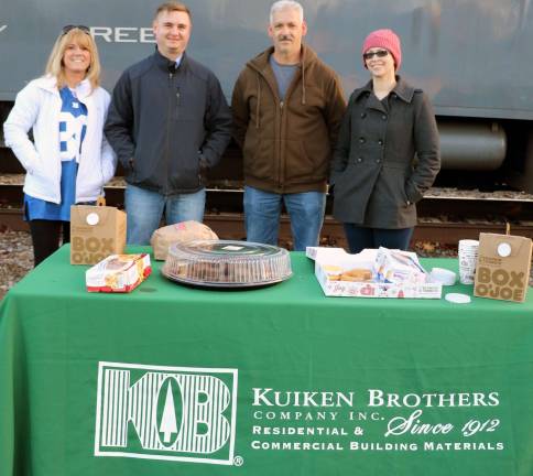 It is starting to feel like Christmas Visitors enjoyed treats courtesy of Kuiken Brothers. From left Communicans Manager Susan Bruno, Store Manager Michael Kuiken, Foreman Frank Santigo and Administrative Assistant Jesica Hays.