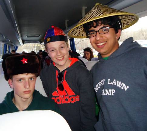 A journey of a thousand miles From left to right are Grant Gottwig of Goshen, Adam Mandel of Warwick and Aaron Goyzueta, also of Goshen, display various types of headwear during a bus trip while the students were in China.