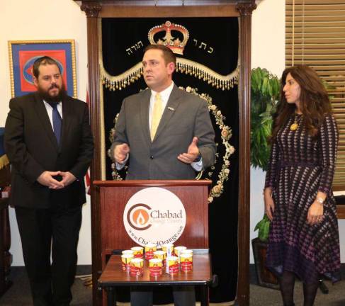 'How do we respond to baseless hatred? Wanton love' County Executive Steve Neuhaus speaks at the Chester healing service flanked by Rabbi and Chana Burston (Photo courtesy of the Orange County Executive)