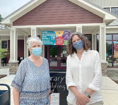 State Sen. Jen Metzger meets with Albert Wisner Public Library director Rosemary Cooper after delivering hand sanitizer to the library's staff.