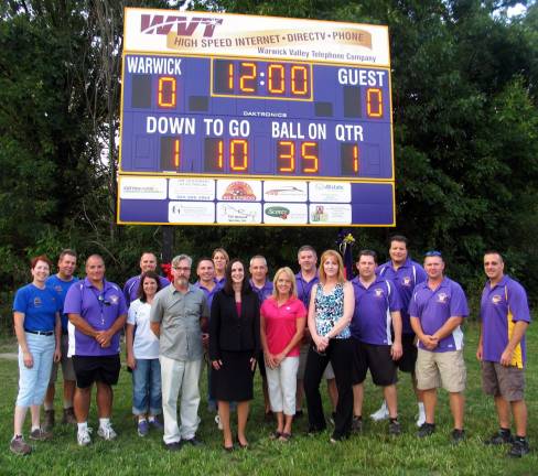 Annual pep rally held for Warwick Youth Football and Cheer Leading Thanks to a contribution by Warwick Valley Telephone, the leagueís annual season kick-off event was also an opportunity to unveil a brand new scoreboard. To thank WVT for the purchase, league officials held a formal ribbon cutting ceremony at the scoreboard with WVT executives. From left, Mary and Jim Leshinski, Percy Caraballo, Kristine Widulski, Todd Orlando, Mayor Michael Newhard, Frank Giordano, Lisa Decker, WVT President Virginia Quackenbush, Scott Hansen, WVT Marketing Director Jean Beattie, WVYFC Board President Brian Perez, WVT Directory Manager Kathy Neu, Scott Walter, Domenico Berlingieri, Paul LeDuc and Bill Garcia.
