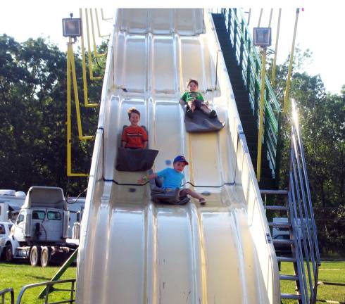 Let the summer begin Photo by Roger Gavan Racing down the slide: From left, Jack Blaikner, 5. Tommy Maiorana, 4, and Jed Unterhalter, 4.