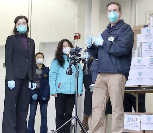 Goshen. Ten thousand surgical masks donated to Orange County first responders, medical personnel Orange County Executive Steven M. Neuhaus speaks to guests at the Emergency Services Center on Monday, April 13. To his left, is Orange County Health Commissioner Dr. Irina Gelman. Members of the ACUC are in the background.