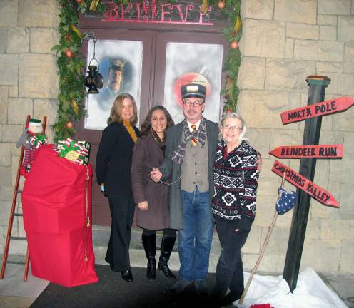 New holiday tradition takes hold in Warwick Photos by Roger Gavan First place: Better Homes & Gardens Rand Realty. From left, agents Kim Starks and Grace Warren, Mayor Michael Newhard and agent Bridget Wallace. The mayor git in the spirit of the railroad theme.