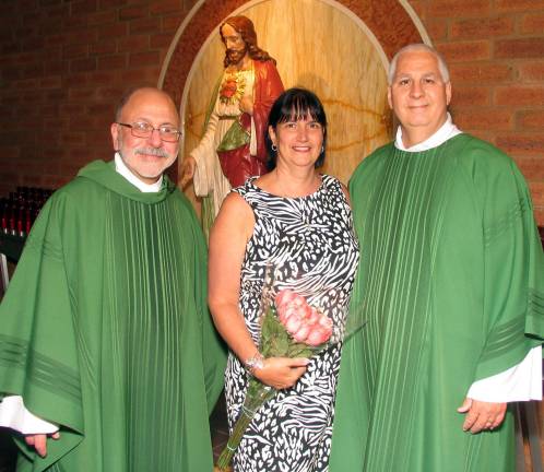 Photo by Roger Gavan Rev. Jack Arlotta (left), pastor of the Church of St. Stephen, the First Martyr, poses with newly ordained Deacon Daniel Byrne and his wife, Teresa.
