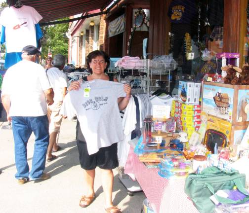 Annual Sidewalk Sale held under clear skies Sue Loughren, co-chair of the Sidewalk Sale,offered specials on her line of T-shirts outside her shop, the Toy Chest.