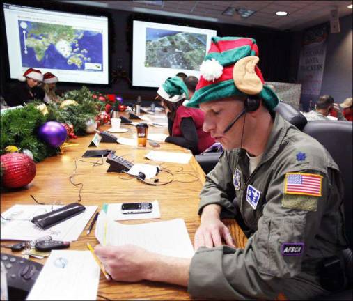 Tracking Santa Air Force Lt. Col. David Hanson takes a phone call from a child in Florida at the Santa Tracking Operations Center at Peterson Air Force Base near Colorado Springs, Colo., during last year's mission.