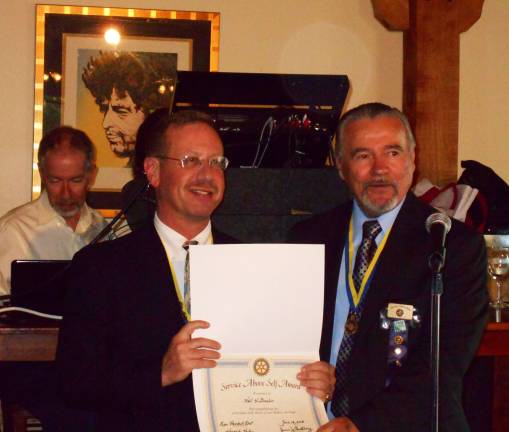 Neil Sinclair heads Warwick Rotary Club Incoming Warwick Rotary President Neil Sinclair receives a ìService Above Self Awardî from outgoing president John Buckley.