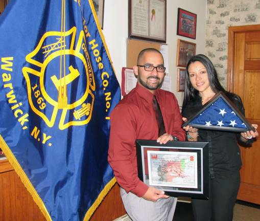 Serviceman returns from Afghanistan with special flag for Warwick Fire Company Photo by Roger Gavan Army Specialist (SPC) Rafael Nieves and his wife, Gina, pose with the American flag that flew over the 980th Engineering Battalion at Kandahar Airfield, Afghanistan on Sept. 11, 2012, and a certificate of authentication from Task Force Lone Star made out to the Excelsior Hose Company.