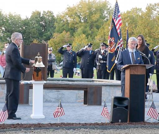 During the ceremony Supervisor Michael Sweeton rang the bell for each name on the memorial read by Mayor Michael Newhard. Photo by Roger Gavan.