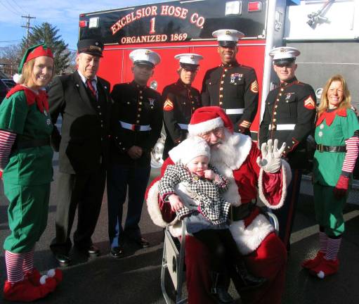 Santa and his elves were also on board and happy to pose for photos with children like Lila Monti, 2, (pictured here) and even adults.