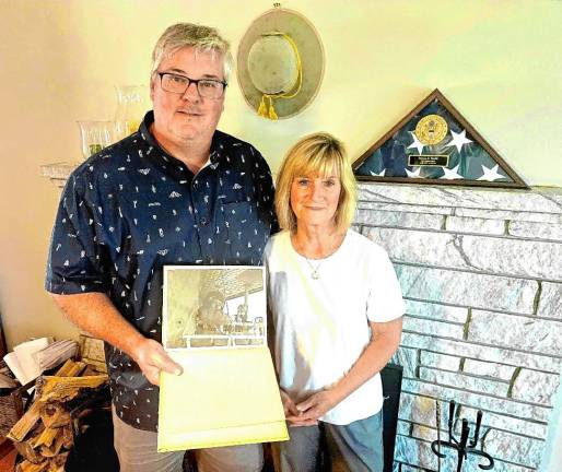 Proud of their service Dave Smith and Kendall Kless at their home in Warwick, N.Y. He holds a photo of his father, Steve, a Vietnam War veteran who died in December. (Photo by Rich Adamonis)