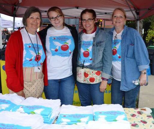 Applefest 2016 draws large crowds despite light rain and cooler weather From left, Marge Porter, Bea Arner, Connie Hegner and Sarah Armand show off this year's Applefest T-shirt at the Warwick Valley Chamber of Commerce booth.