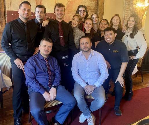 Grappa Ristorante owners, front from left, Nick Ahmetaj and Tony Sylaj, with their staff contributed to the success of the ninth annual Fall Fling dinner for Backpack Snack Attack. Provided photo.