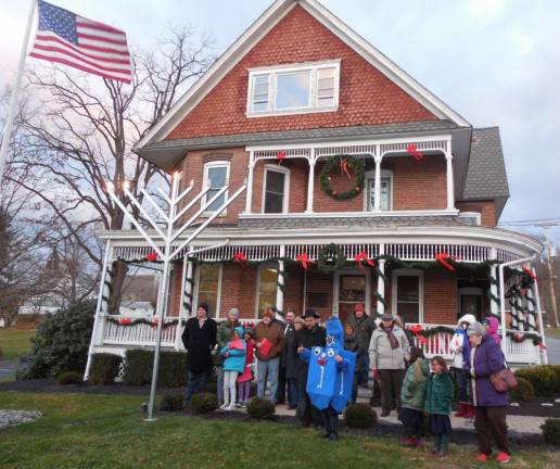 On the very cold and blustery afternoon of Monday, Nov. 29, the Village of Florida celebrated the lighting of the Hanukkah menorah on the lawn of the Village Hall. Rabbi Meir Borenstein of the Chabad Center of Orange County in Goshen led the crowd in a greeting and blessing and Mayor Dan Harter Jr. lit the candles to begin the celebration. Photo provided by Beth Fuller/Florida Chamber of Commerce.