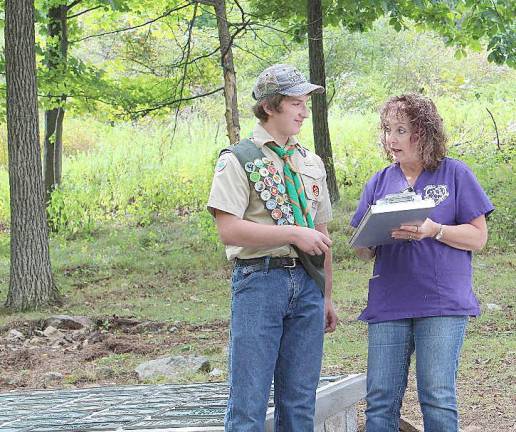 Scout Hunter Endrikat discusses his Eagle Scout project with Suzyn Barron of the Warwick Valley Humane Society at the “Resting Paws Pet Cemetery.