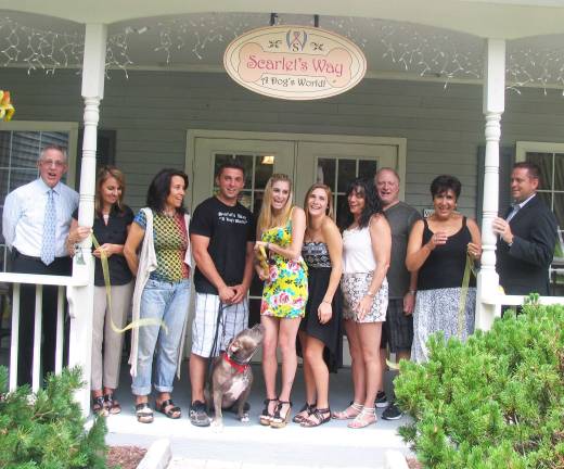 Scarlet’s Way celebrates official grand opening Photo by Roger Gavan Town of Chester Supervisor Steve Neuhaus and members of the Warwick Valley and Sugar Loaf Chambers of Commerce joined owner Kayla Scarane and her family and friend for an official grand opening and ribbon cutting of Scarletís Way, a Dogís World on Thursday, June 27. From left, Michael Johndrow, executive director of the Warwick Valley Chamber of Commerce; Board member Nicole Repose, Sugar Loaf Chamber of Commerce President Kiki Rosner, John Shamarek, owner Kayla Scarane, her sister Layna Scarane, her mother and father, Elaine and Nick Scarene, Warwick Chamber Vice President Sherry Bukovcan and Town of Chester Supervisor Steve Neuhaus. In front: ìScarlet.î