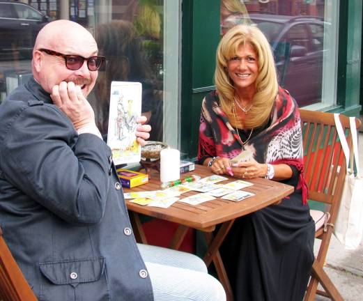 Warwick will be dressed in pink Friday Photo by Roger Gavan Pink Friday Chairman Tim Mullally pretends his card is not the one he wanted from Tarrot Card reader Yvonne Gangone.