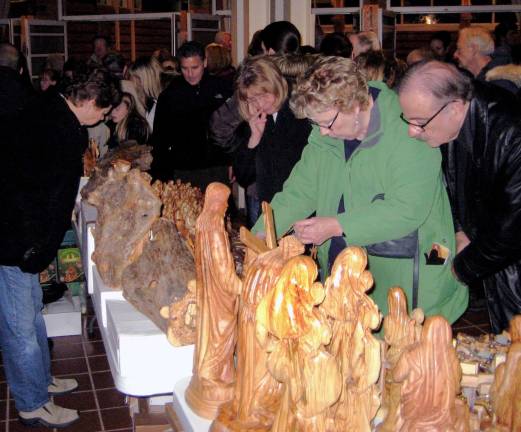 Gift items from Bethlehem offered at St. Stephen's Photo by Roger Gavan Parishioners view a large selection of religious carvings made from the olive tree, which is frequently referred to in the Gospels.