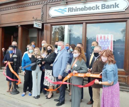 On Monday, May 17, elected officials along with members of the Orange County and Warwick Chambers of Commerce joined Rhinebeck Bank officials and staff to celebrate the bank’s newest branch location at 62 Main St., Suite 1 in Warwick. Branch Team Leader Diane Milo and Diane Passaro, Rhinebeck Bank vice president/market manager cut the two ribbons provided by both Chambers of Commerce. Photo by Roger Gavan.
