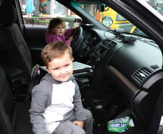 Village of Warwick celebrates First Responders Day Sophie Burns, 2, and her brother Liam, 3, had an opportunity to play cops and robbers by sitting behind the wheel and special equipment in a real patrol car.