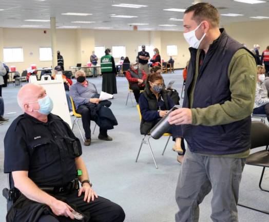 Orange County Executive Steven M. Neuhaus talks to Town of Mount Hope Police Officer Sean Burke at a county vaccination clinic on Jan. 21, 2021, on Hatfield Lane in Goshen. Photo provided by Orange County.