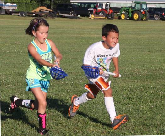 Catching up Among the activities at the Village of Warwick summer recreation program was lacrosse. Here, Sami Brady and Hunter Ludovicy show their speed, skill and enthusiasm for the game.