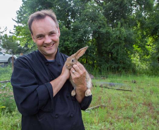 Farm fresh to the restaurant table Florian Wehrli, Executive Sous Chef of Crystal Springs Resort, cuddles with a rabbit on the farm.