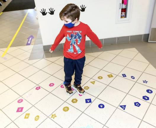 One of the sensory path activities for students is to tiptoe on letters of the alphabet arranged in a figure eight.