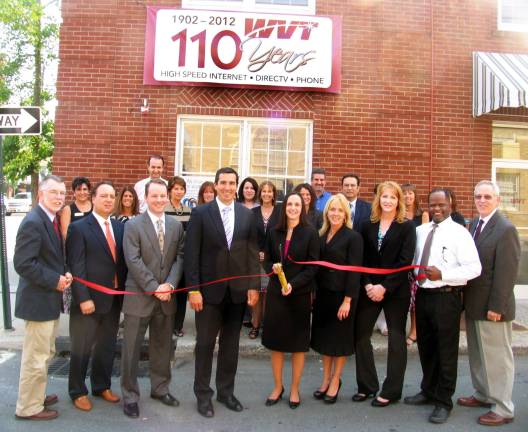 Warwick Valley Telephone at 110 Photo by Roger Gavan Front from left, Town of Warwick Supervisor Michael Sweeton, Jeffrey Alario, member of the WVT Communications Group Board of Directors; Brian Callahan, executive vice president, CFO and treasurer of WVT Communications Group; David Cuthbert, president and COO of WVT Communications Group; Virginia Quackenbush, president, Warwick Valley Telephone; Jean Beattie, marketing director, Warwick Valley Telephone; Kathy Neu, directory manager, Warwick Valley Telephone; Cedric Glasper, president of the Warwick Valley Chamber of Commerce; Michael Johndrow, executive director of the Warwick Chamber. Rear, local officials, WVT employees and members of the Warwick Valley Chamber of Commerce Board of Directors.
