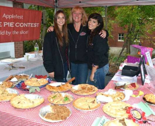 Applefest 2016 draws large crowds despite light rain and cooler weather Sarah Robinson, Sara Giarratano, and Leslie Nobel of Nobel Pies watch over the apple pies following the pie-judging contest.