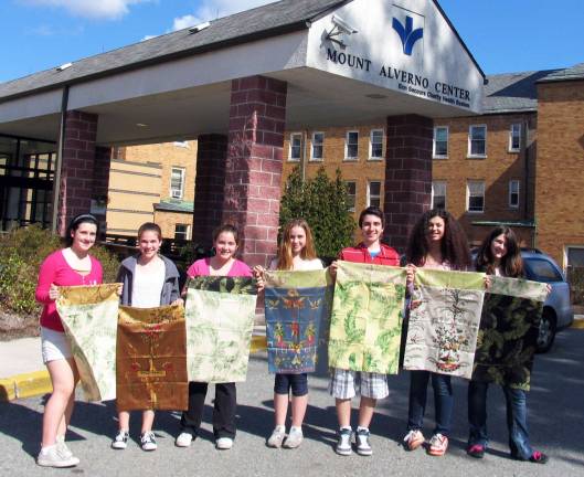 Middle School students present handmade pillow cases to Mount Alverno residents From left are students Juliet Lepe, Sara Truncali, Nicole Ramirez, Bria Metzger, Matt Tomko, Gillian Perez and Shannon Halligan. Students not present for this photo include Tori Anderson, Julia Keys, Patrick Valentine and Medina Rier.