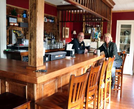 Baird Tavern returns to its original purpose Photo by Roger Gavan Tavern co-owner Adam Powers and Historical Society Executive Director Lisa Weisbrod discuss the operation of the new Baird Tavern at its replica of an old time “Cage Bar.”
