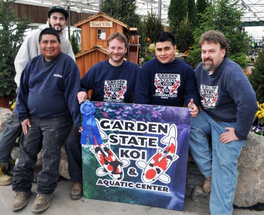The People’s Choice Provided photo Landscape designer Tim Dille (center) displays first place ribbon for garden design þÄúToad VilleþÄù that captured the PeopleþÄôs Choice Award at the Springfest Flower and Garden Show.