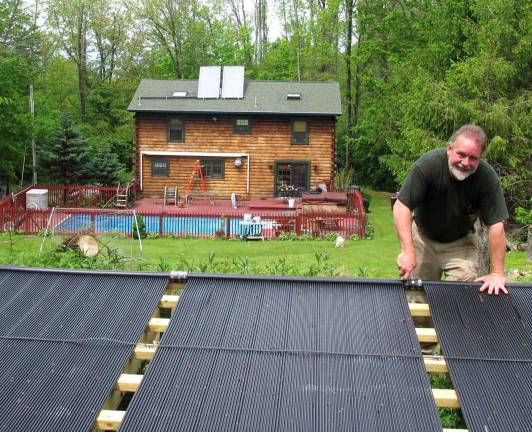 Gallagher Solar Thermal named Master Dealer for Solar Industries Photo by Roger Gavan Patrick Gallagher installing a pool solar heating system.