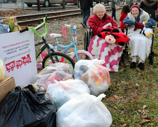 Mount Alverno residents contribute to the success of Operation Toy Train Provided photo Mount Alverno residents Dorothy Wilson (left) and Helen Mc Keon greeted the U.S. Marine Corps Reserve’s annual “Operation Toy Train,” with eight bags of toys collected by all the residents.