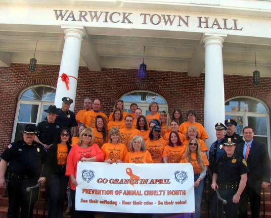 Protecting creatures great and small On Wednesday, April 15, Orange County Executive Steve Neuhaus and representatives of County and local law enforcement agencies joined Town of Warwick personnel and animal shelter staff, who were all wearing orange tee shirts, to support the Warwick Valley Humane SocietyþÄôs campaign of Go Orange for Animals. Law Enforcement representatives in the photograph posing outside the railings: Left from front to rear, Village of Chester Chief Graziano, Orange County Sheriff's Dept. Deputy Cottone and Village of Florida Chief Coleman. Right from front to rear, Town of Chester Chief Doellinger, Town of Warwick Chief McGovern, and Town of Chester Sgt. Vitale. County Executive Steve Neuhaus is at far right and Suzyn Barron, president of the Warwick Valley Humane Society is at far left of front row inside the railing.