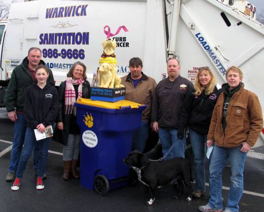 Stolen Guiding Eyes Donation Dog statue replaced by local business group Photo by Roger Gavan Four local business owners contributed to the replacement of a stolen Donation Dog statue used to help defray the cost of medications for puppies being raised by volunteers to become Guide Dogs for the blind and visually impaired. From left, G & T Auto Parts owner Tom Kobylaski with his daughter Katie, 13; Warwick resident Cheryl De Vine, an Orange County region volunteer ìpuppy raiser;î Emma, the Donation Dog; Guy Bogart, owner of Warwick Sanitation; Adam Powers, owner of Fetch Bar and Grill; Dottie Sanford of Warwick Sanitation; and Betsy Mitchell, co-owner of Track 7 Postal Center.