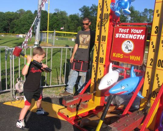 Let the summer begin Photos by Roger Gavan Testing his strength and he rang the bell and won a prize - Daniel Noviski, 6.