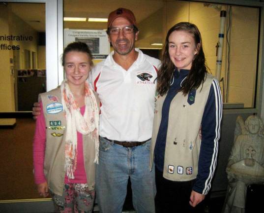 100 pairs of shoes Sisters Orla and Sinead Brosnan of the Village of Florida collected and delivered more than 100 pairs of news shoes to James Regan, athletic and admissions director of the Martin Luther School in Maspeth, Queens, who will distributor these to kids who were affected by Hurricane Sandy. Pictured from left to right are Orla Brosnan, James Regan and Sinead Brosnan.