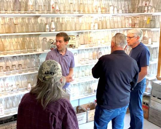 Prizgintas shares the history of his earliest milk bottles to attendees at the Orange County Milk Bottle Museum’s open house in early June. With the museum holding more than 800 milk bottles, they are often the last surviving artifacts of many dairy farms that have long since vanished from the region.