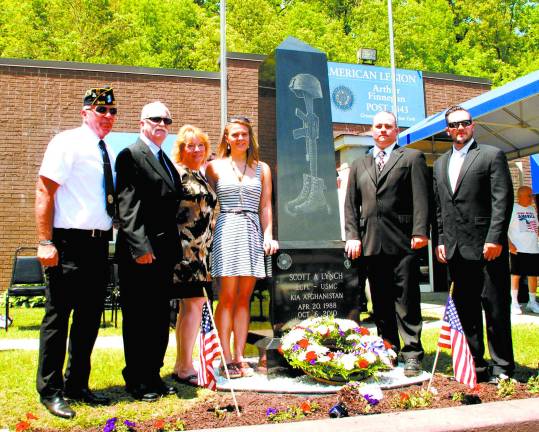 Greenwood Lake remembers one of its own Photos by Ed Bailey Standing by the monument are Legion Commander Patrick Buckley, Scott LynchþÄôs father Jim, his mother Tammy, wife Tanya and brothers Jerry and and Jimmy.