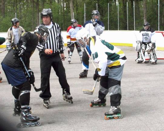Warwick gains Home Rink Advantage Referee Tony Romagnino, who also is the president of the Monroe-Woodbury Roller Hockey League, is set to drop the ball for a face-off in the first game of roller hockey.