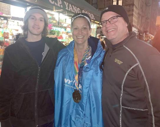 Kristin Jedziniak flanked by her son Dalton and husband Eric.